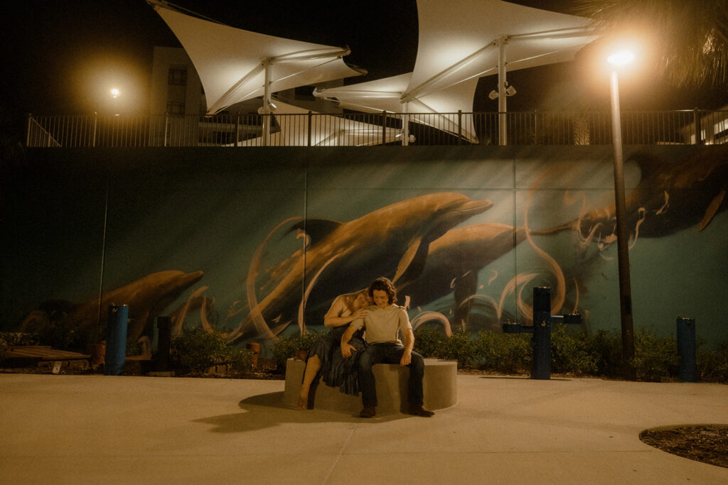 Moody blue hour photography session with tall buildings glowing in the background