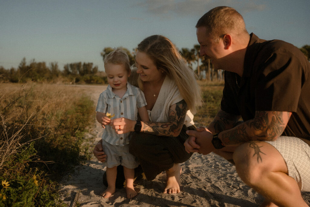 Family walking through by sea grass during a storytelling family session in Tampa Bay