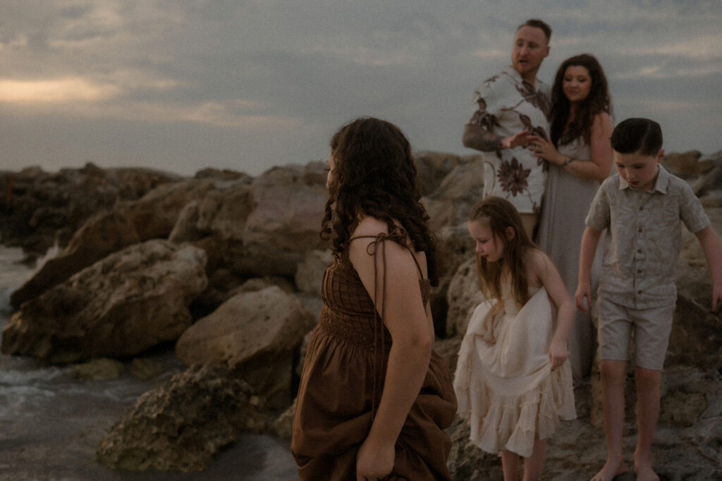 Family wearing rich colors on a cloudy day at a Florida Beach